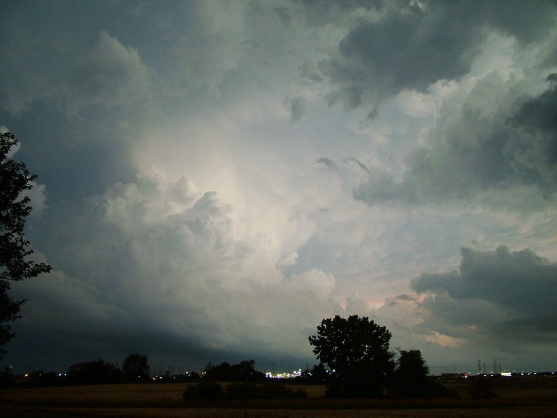 Storm clouds over an open field at dusk.